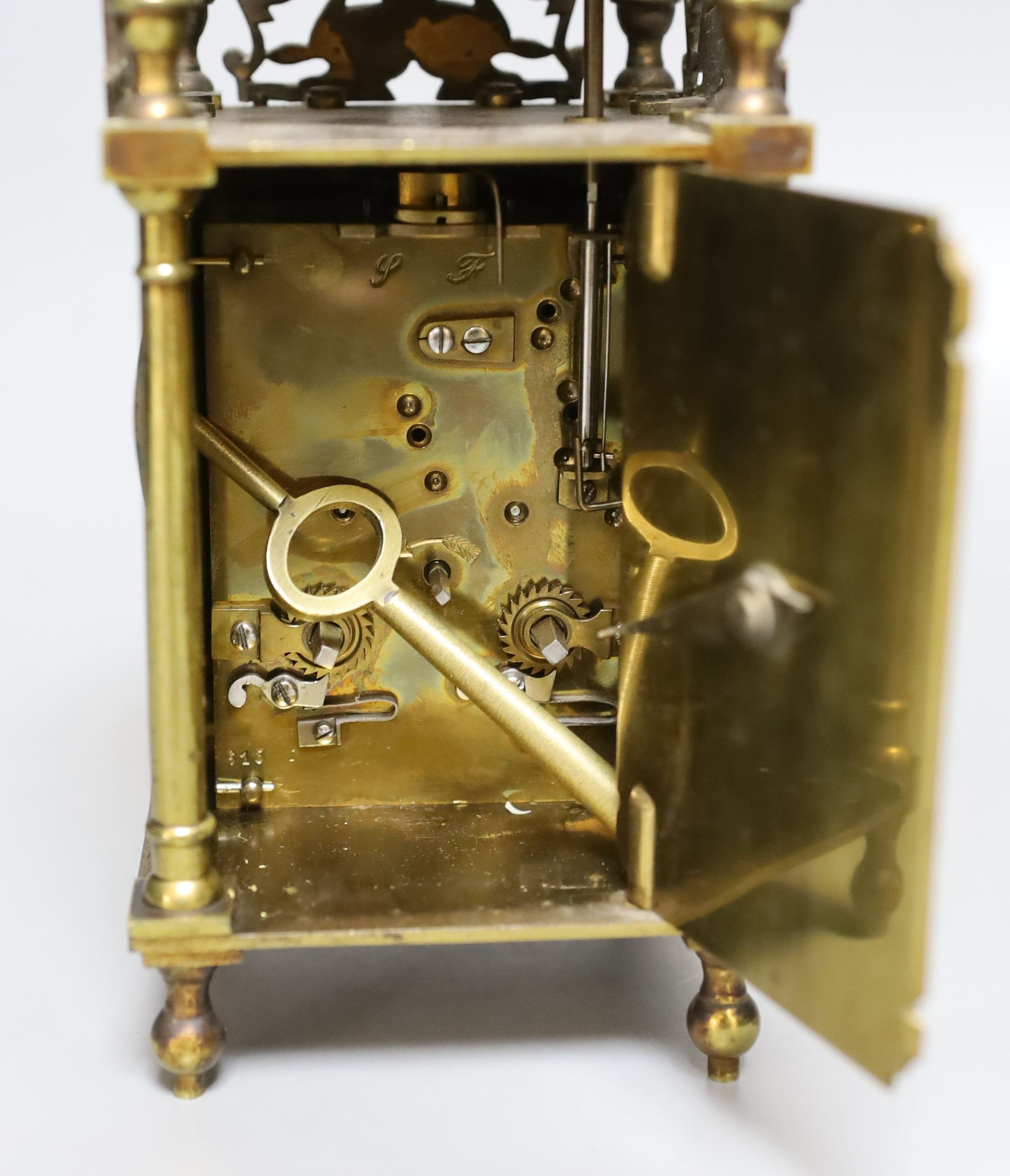 A 19th century miniature brass lantern clock, with key. 24cm